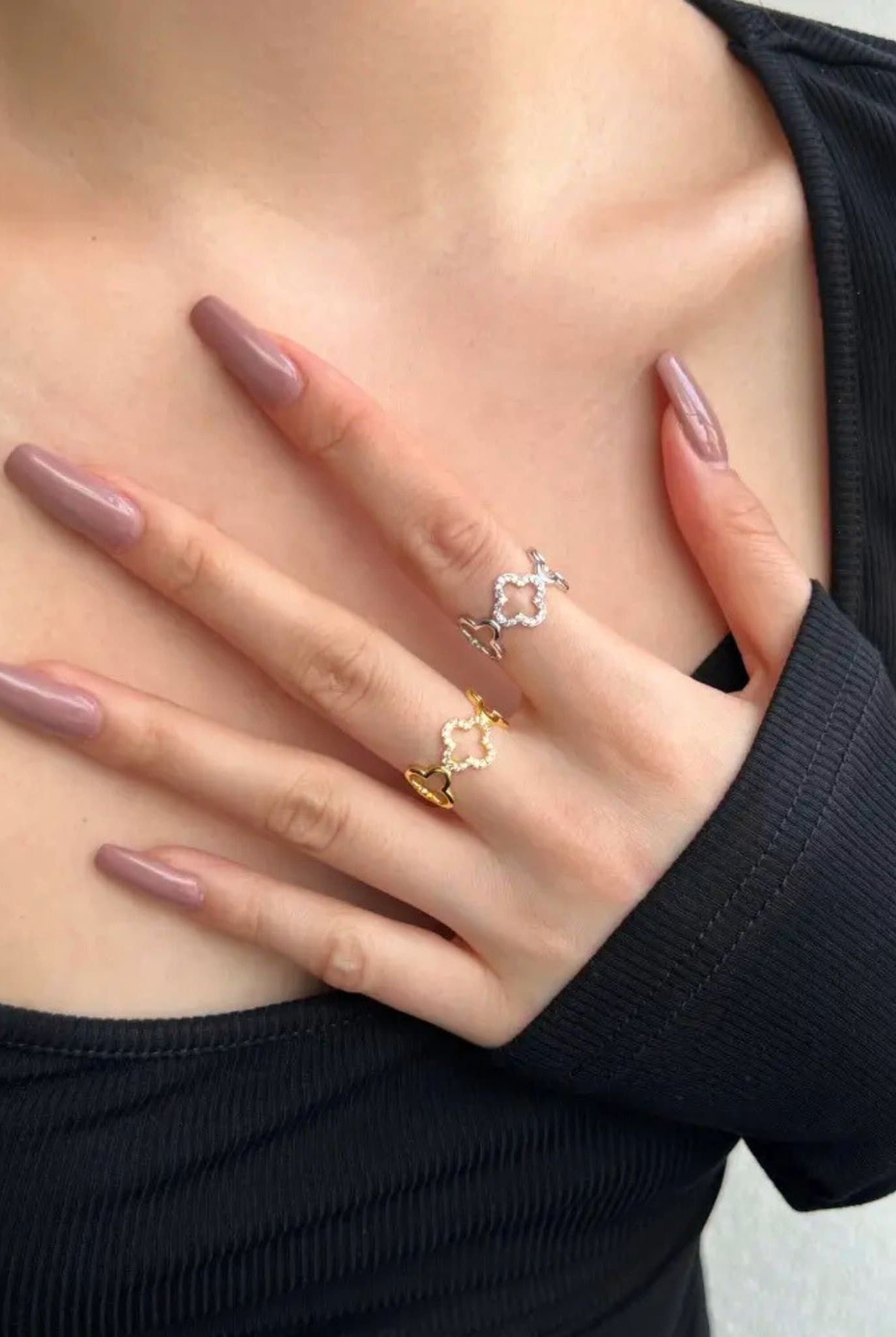 Elegant gold clover ring worn on hand, showcasing its delicate design.