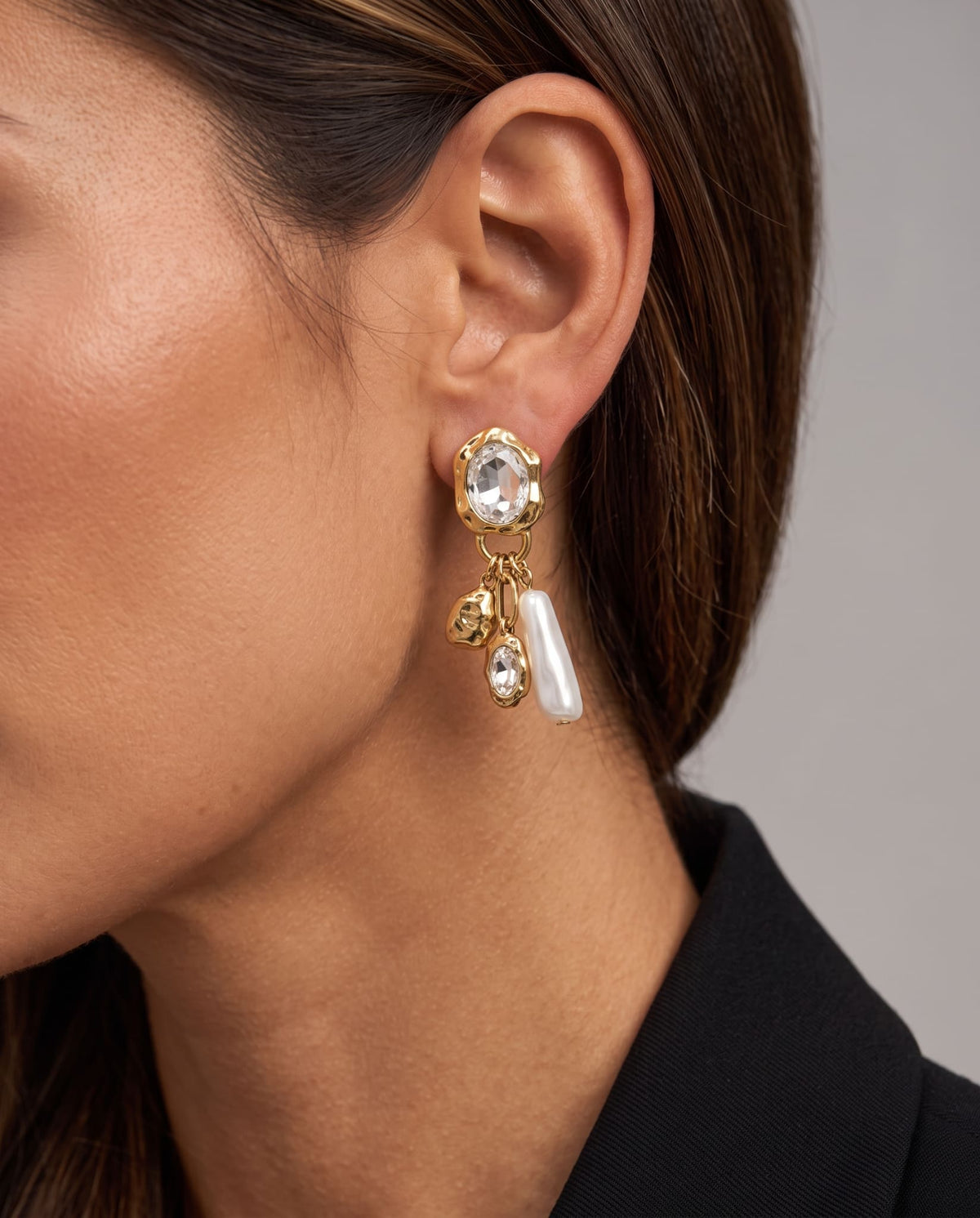 Crystal & Pearl Drop Earrings worn on the ear with gold-tone details and dangling charms.
