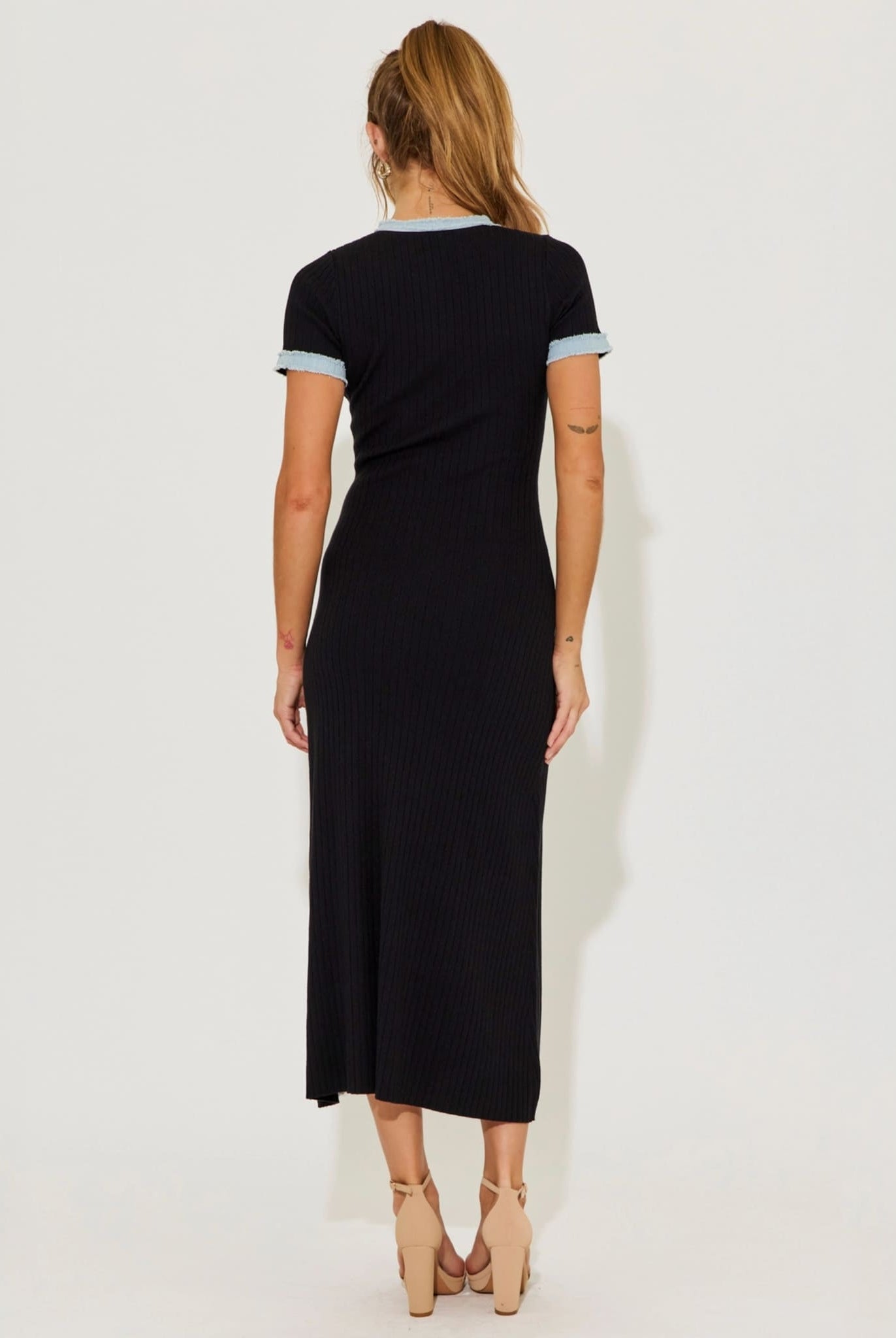 Black ribbed knit midi dress back view on model.