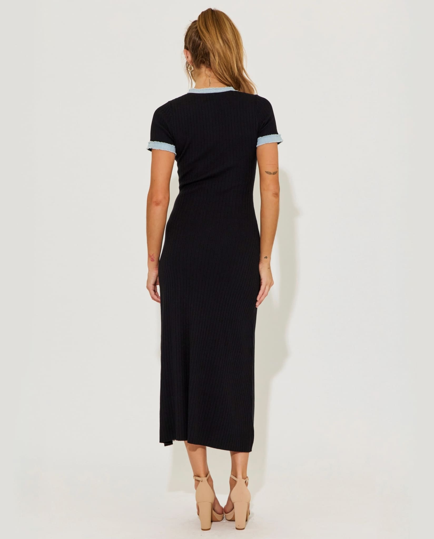 Black ribbed knit midi dress back view on model.