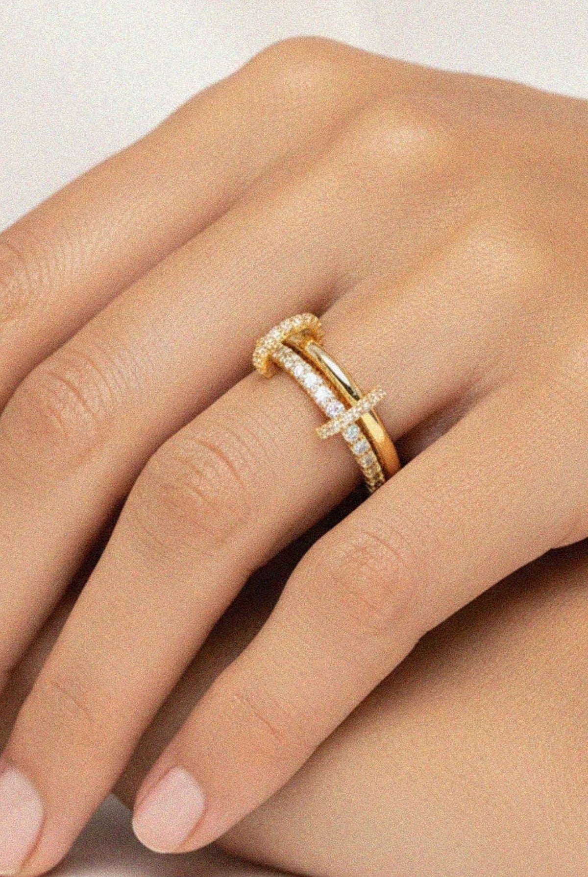 Gold-tone double band ring with sparkling pavé detailing.