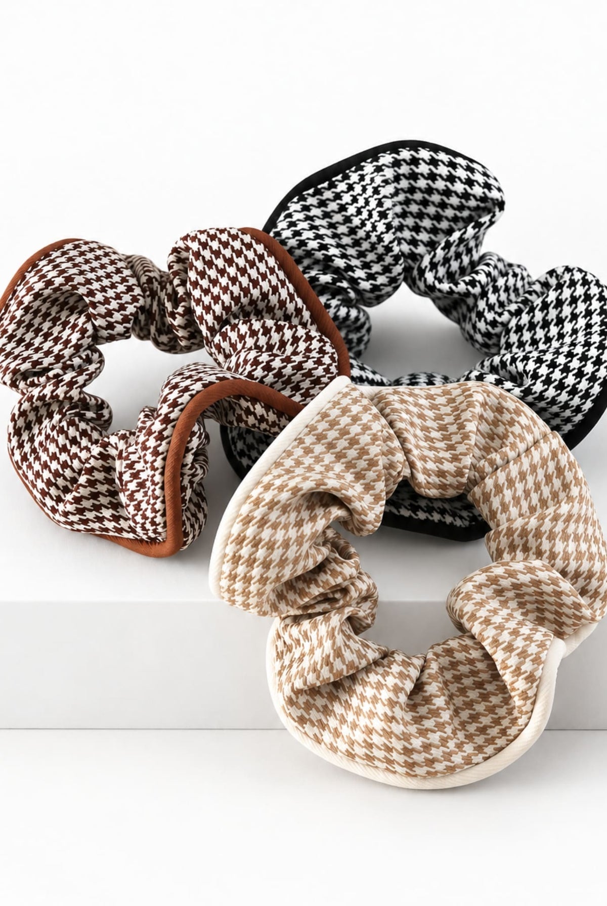 Brown, beige and black houndstooth hair scrunchies.