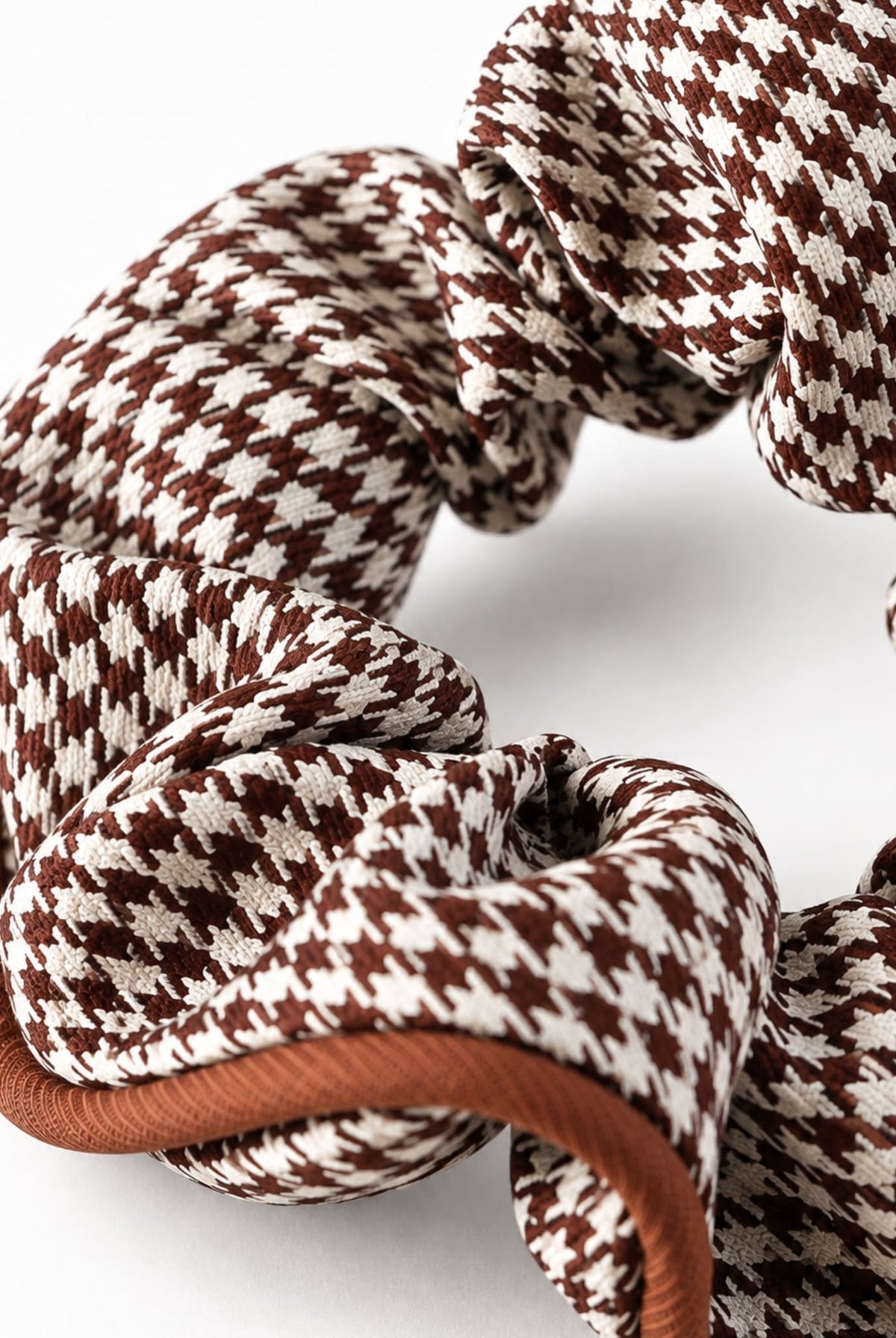 Close-up of houndstooth hair scrunchie in brown.
