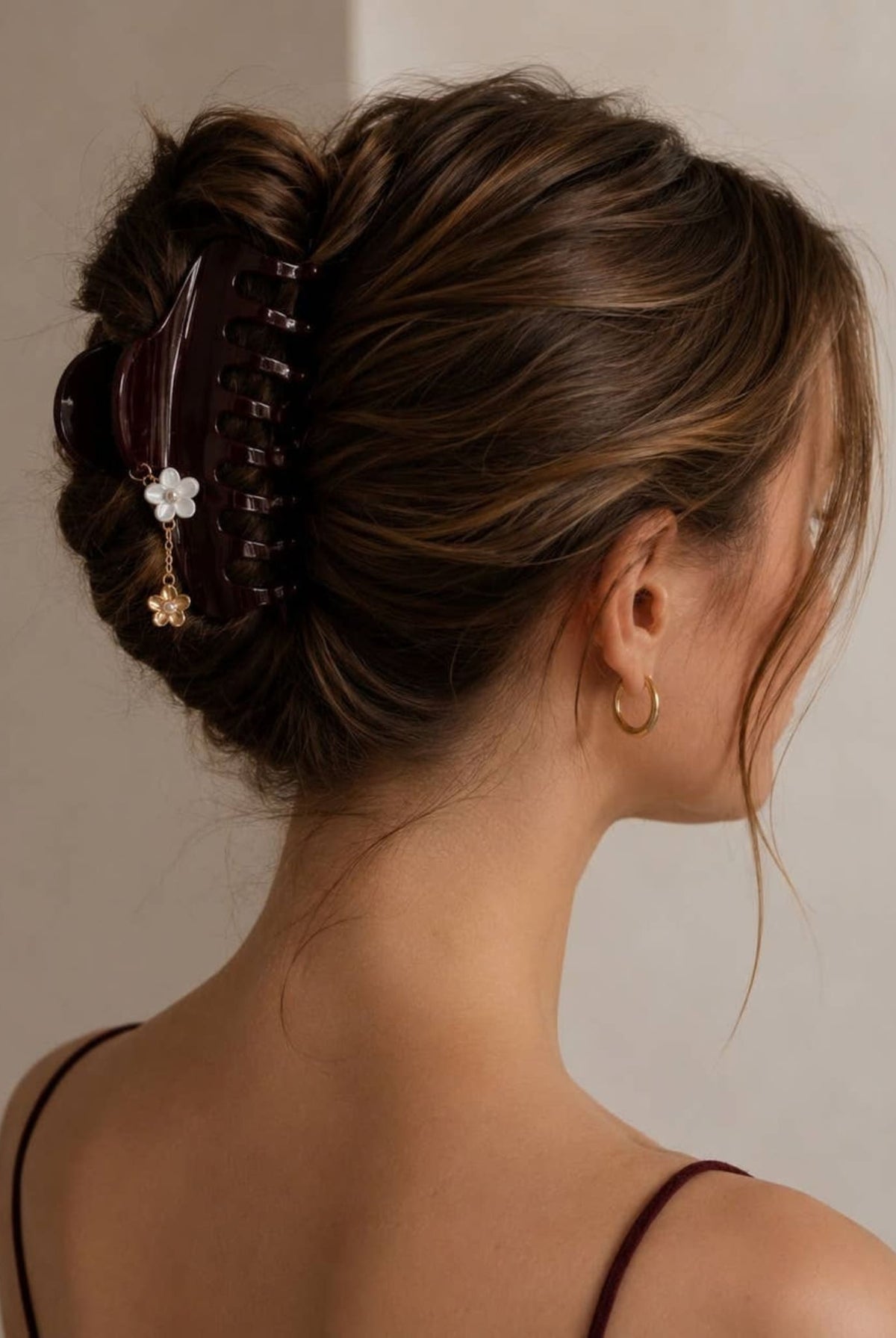 Large burgundy hair claw styled in an elegant updo.