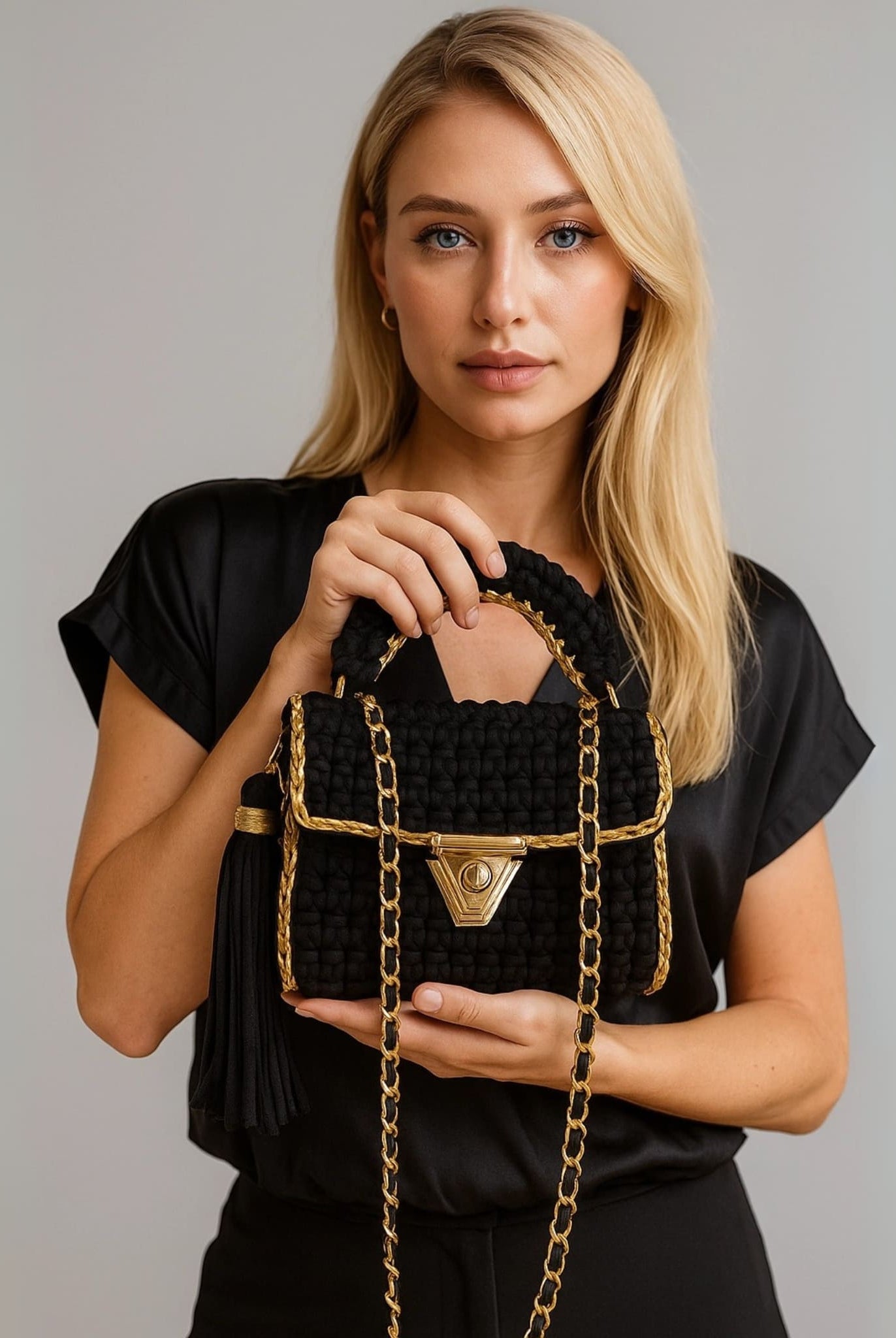 Model showcasing the noir chic crochet bag from Coventina Collection