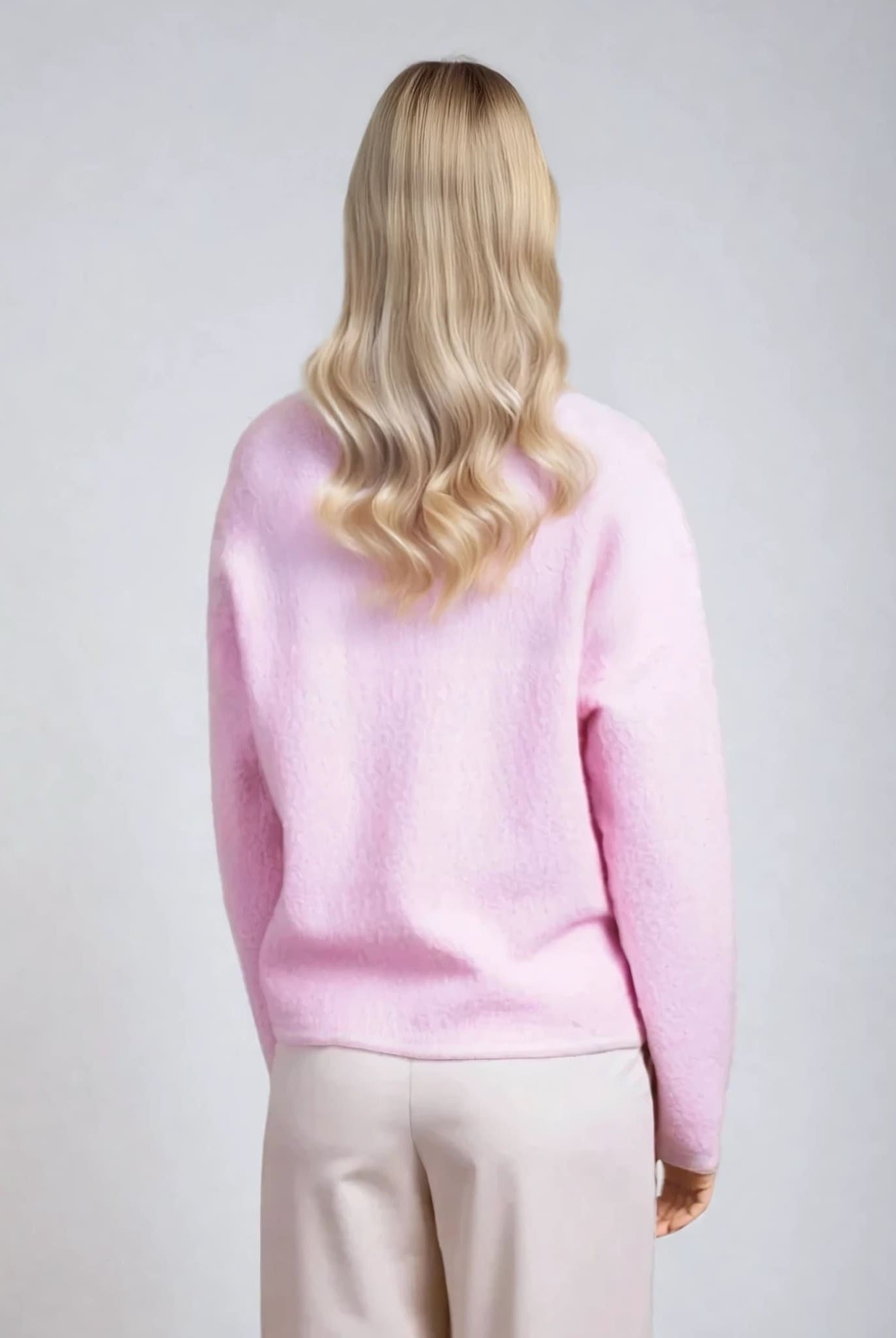 Back view of powder pink textured cardigan, soft women's knitwear from Coventina Collection.