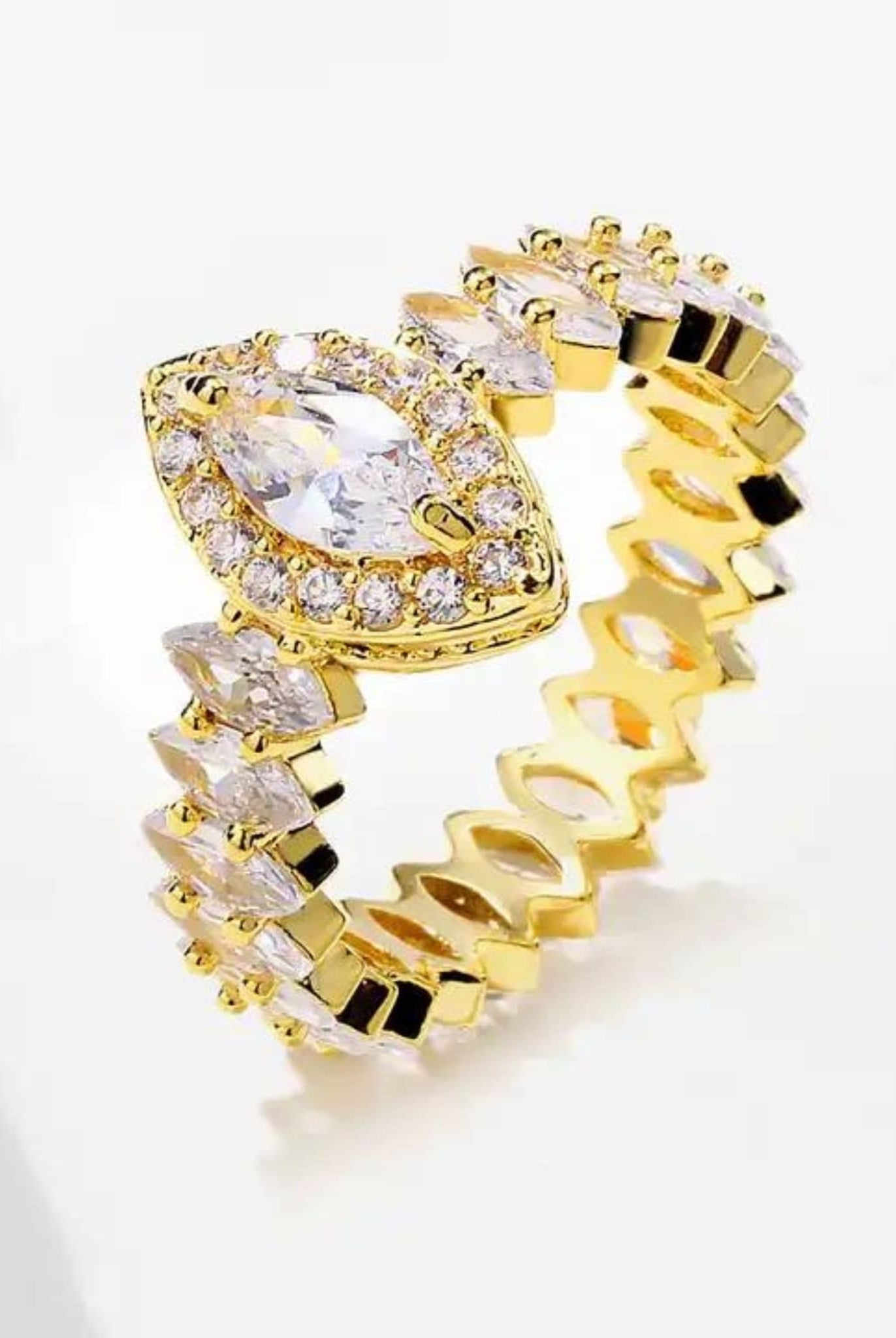 Detailed view of gold marquise ring with sparkling zircon stones.