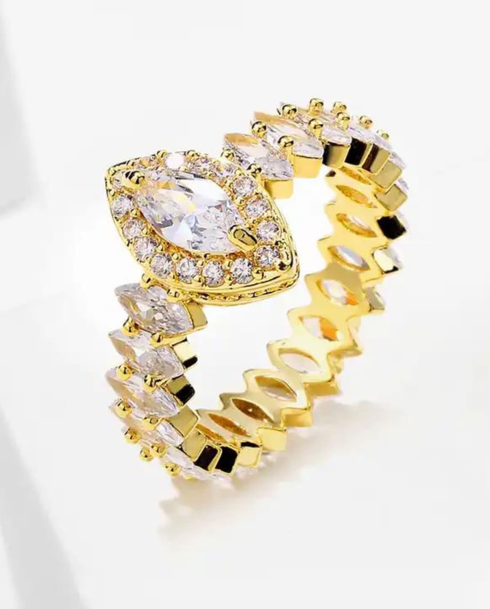 Detailed view of gold marquise ring with sparkling zircon stones.