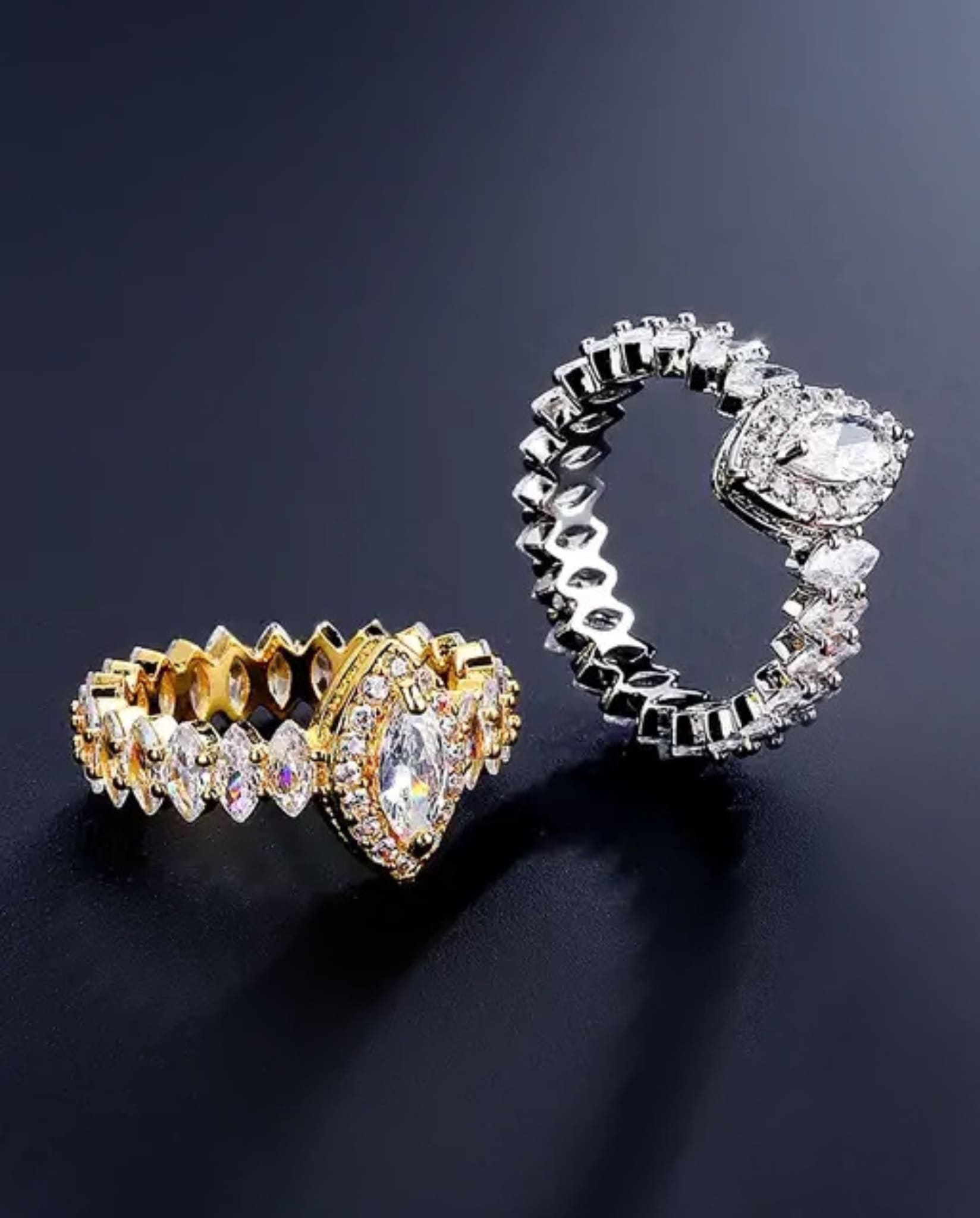 Silver and gold marquise rings with zircon stones.