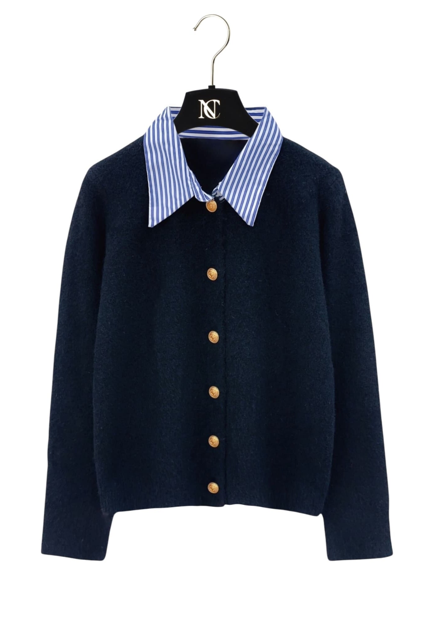 Striped collar cardigan in black with gold buttons from Coventina Collection displayed on hanger.