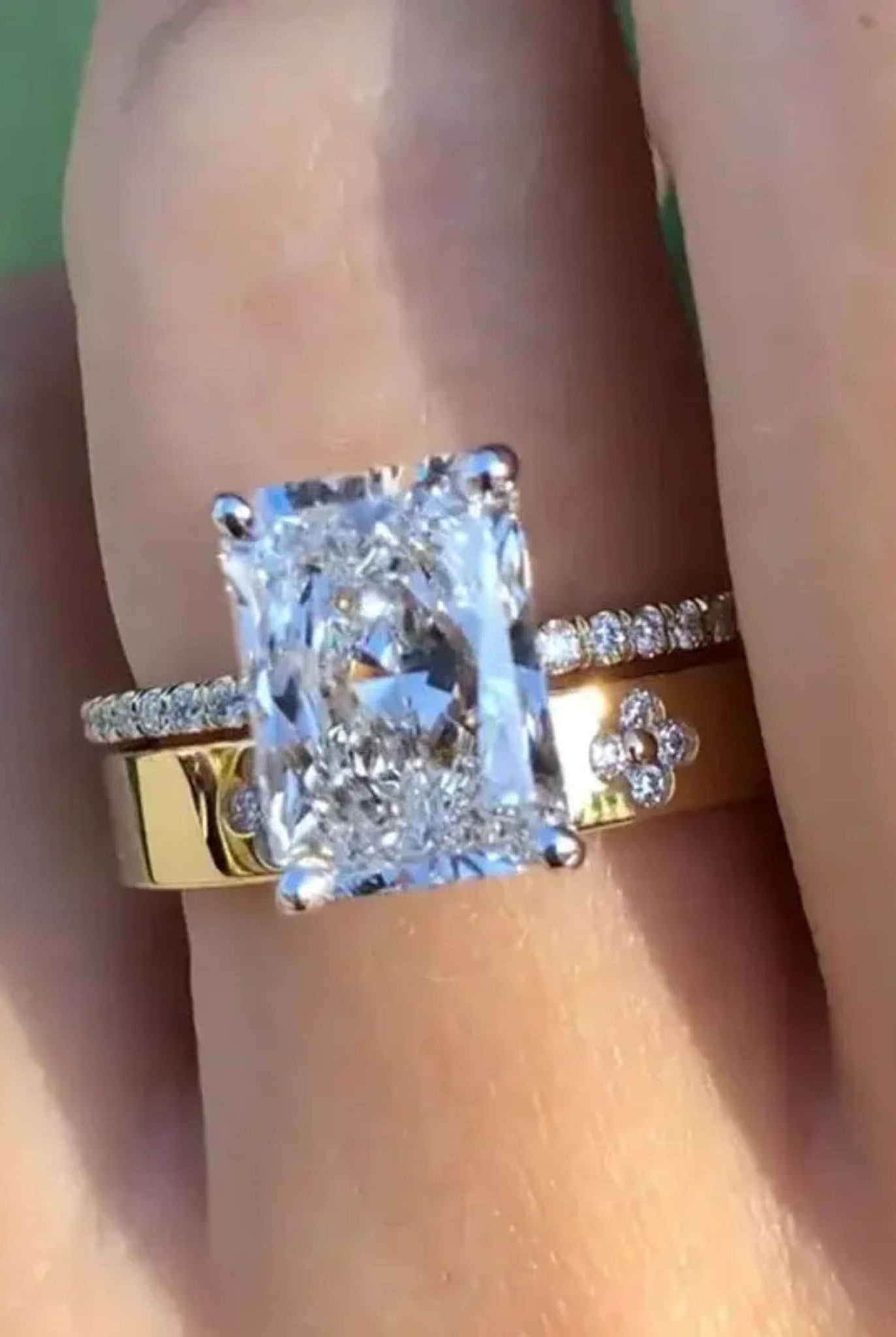 Gold two-piece radiant ring set worn on hand, showing radiant-cut stone and delicate band details.