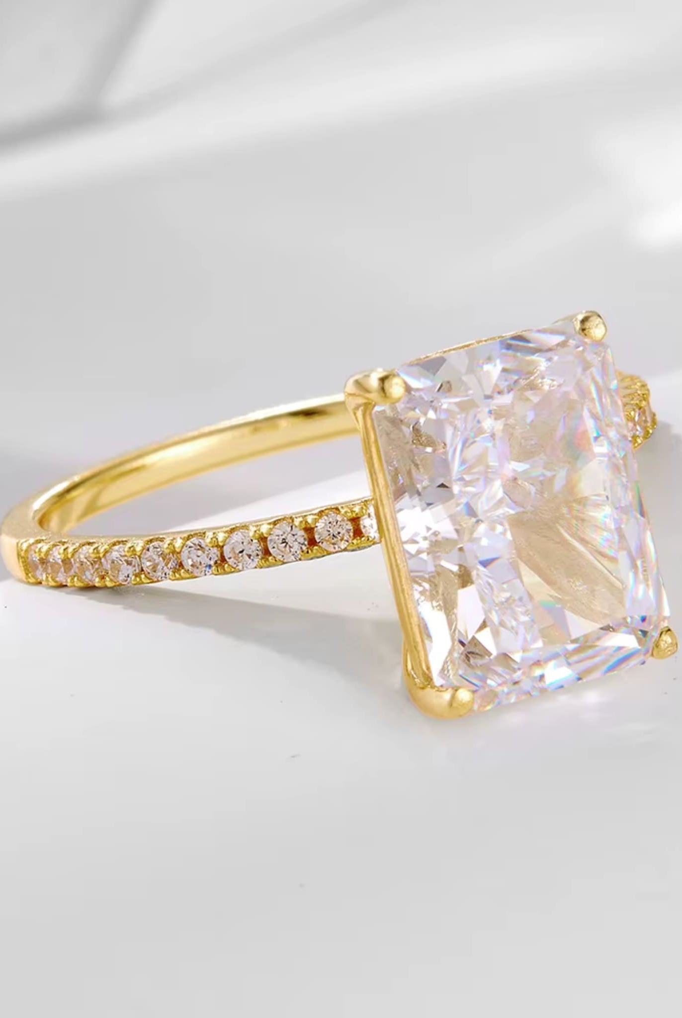 Elegant radiant-cut ring in gold from the two-piece radiant ring set, captured from a side angle.