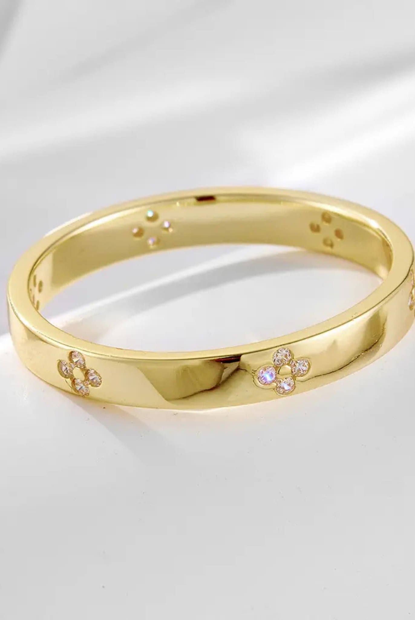 Gold band with floral diamond details from the two-piece radiant ring set.