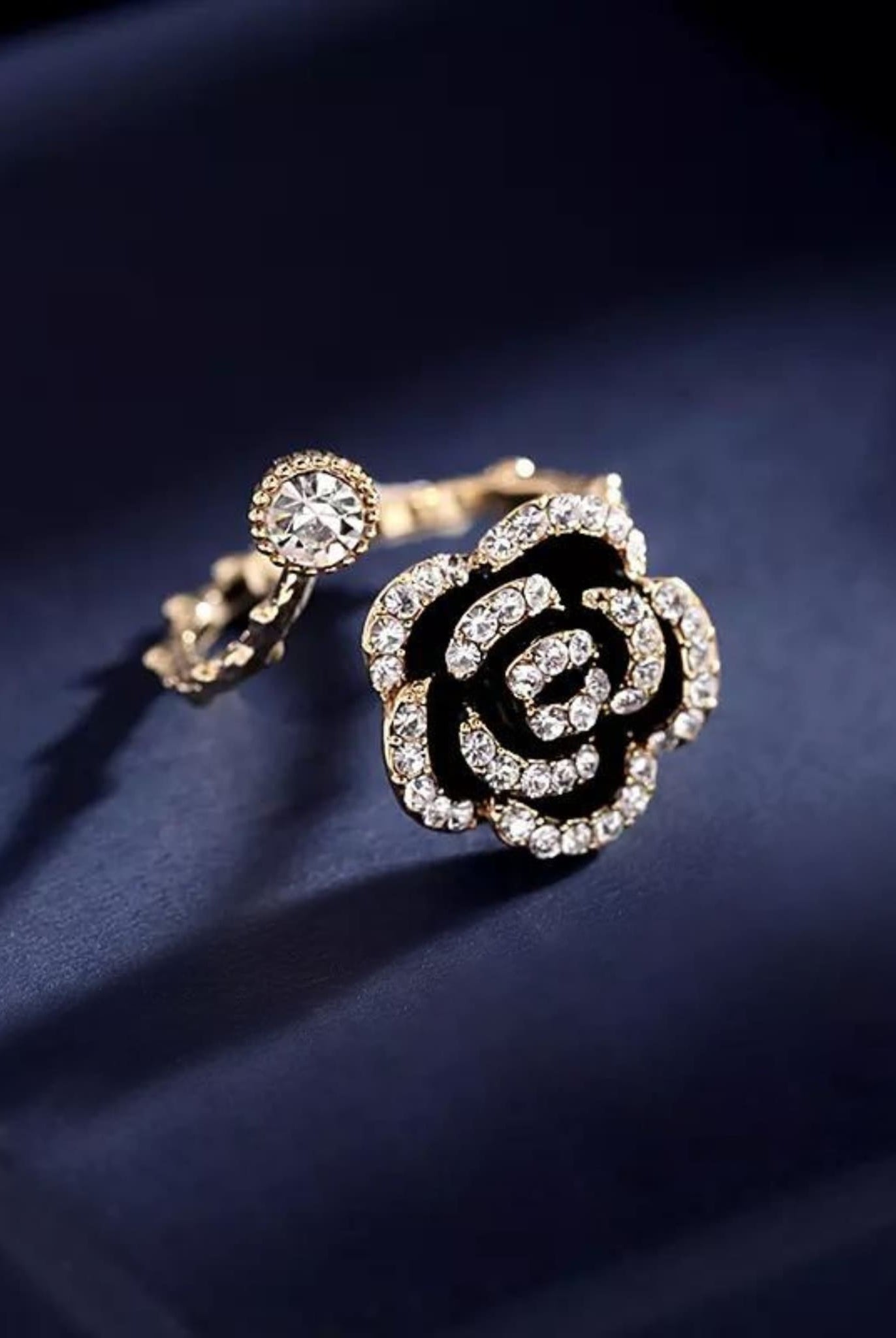 Gold open band Camellia Flower Ring with rhinestones and black enamel details.
