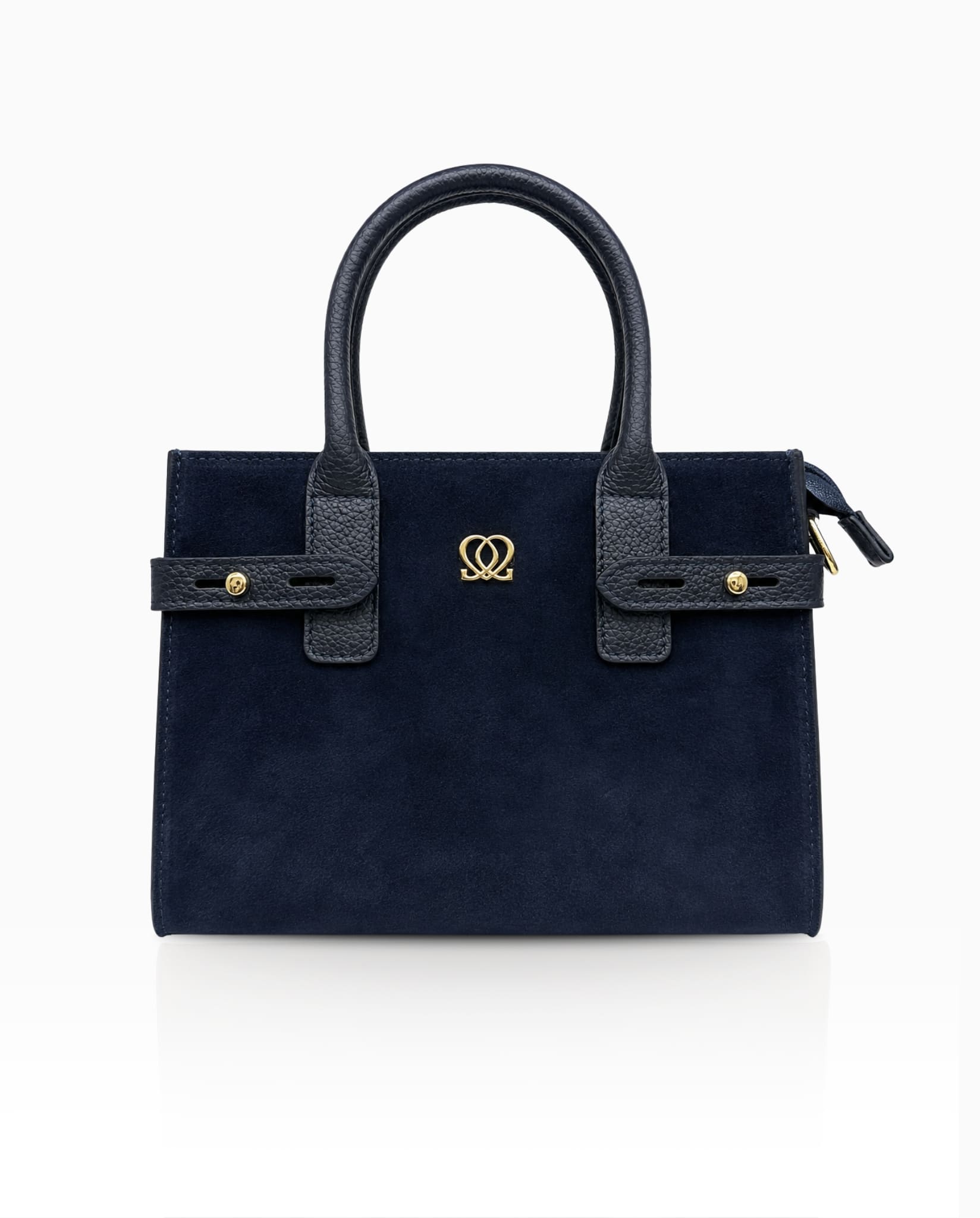 Navy leather handbag with suede front panel and gold-tone detailing.