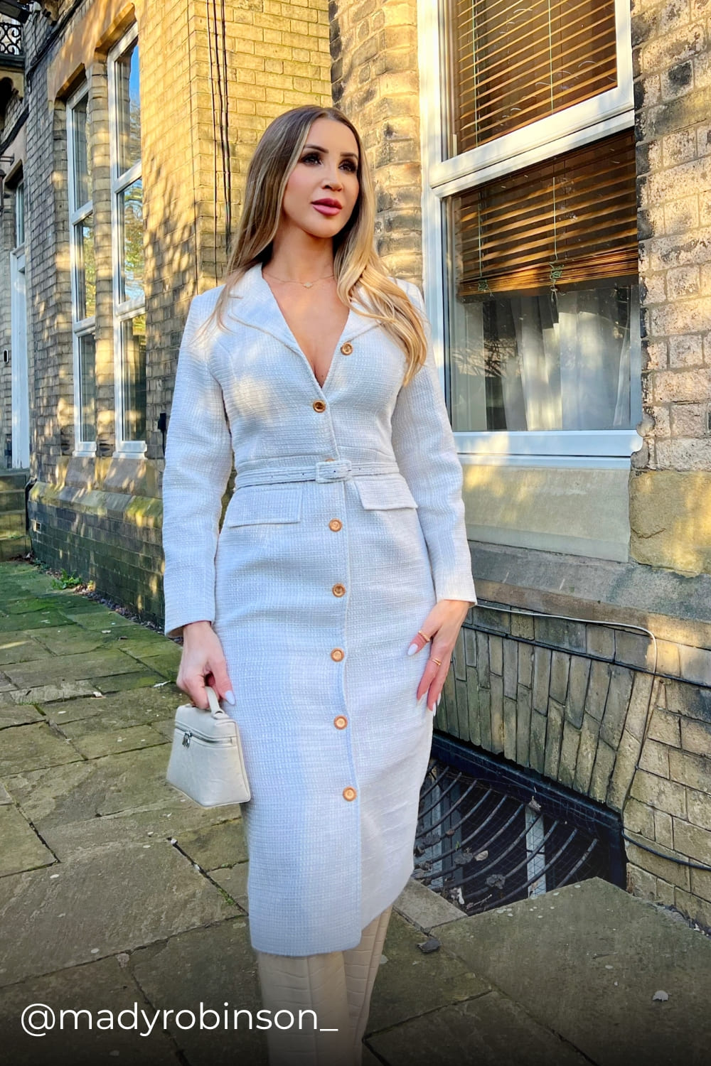 Mady wearing an elegant tweed dress with belt from Coventina Collection