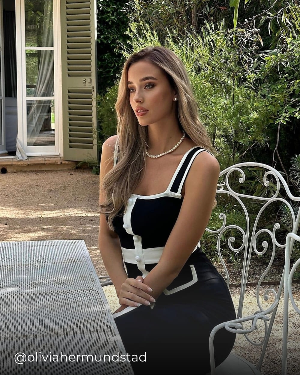 @oliviahermundstad wearing the classic summer dress with white trim from Coventina Collection