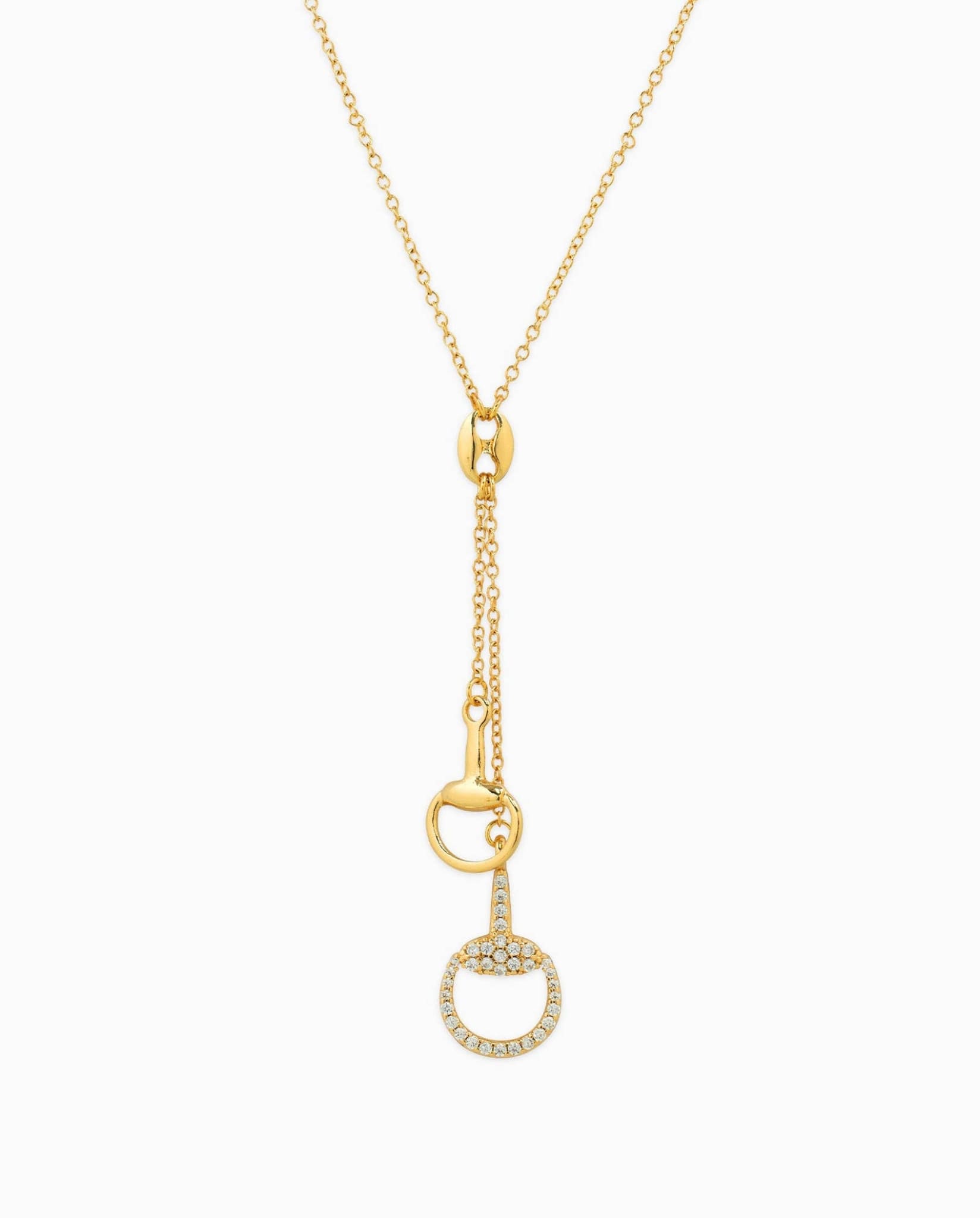 Gold drop necklace with horse bit pendants and crystal detailing.