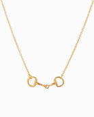 Gold chain necklace with horse bit pendant on white background.