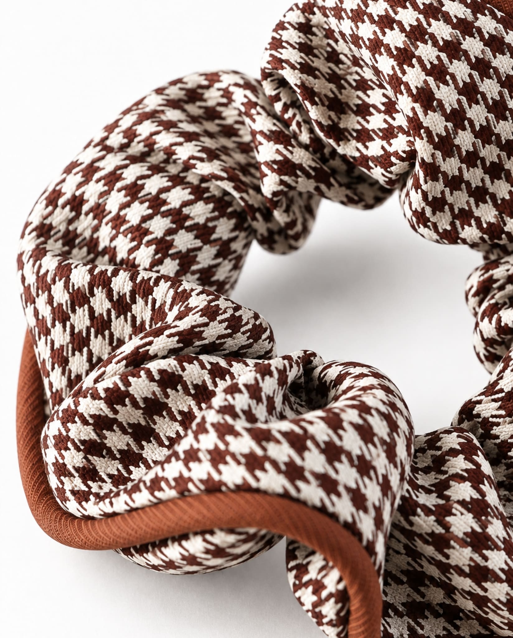 Close-up of houndstooth hair scrunchie in brown.