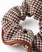 Close-up of houndstooth hair scrunchie in brown.