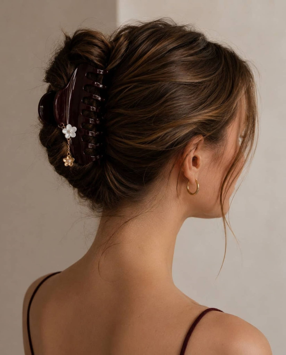 Large burgundy hair claw styled in an elegant updo.