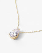 Detailed view of gold teardrop pendant with brilliant-cut stone and fine setting.