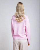 Back view of powder pink textured cardigan, soft women's knitwear from Coventina Collection.