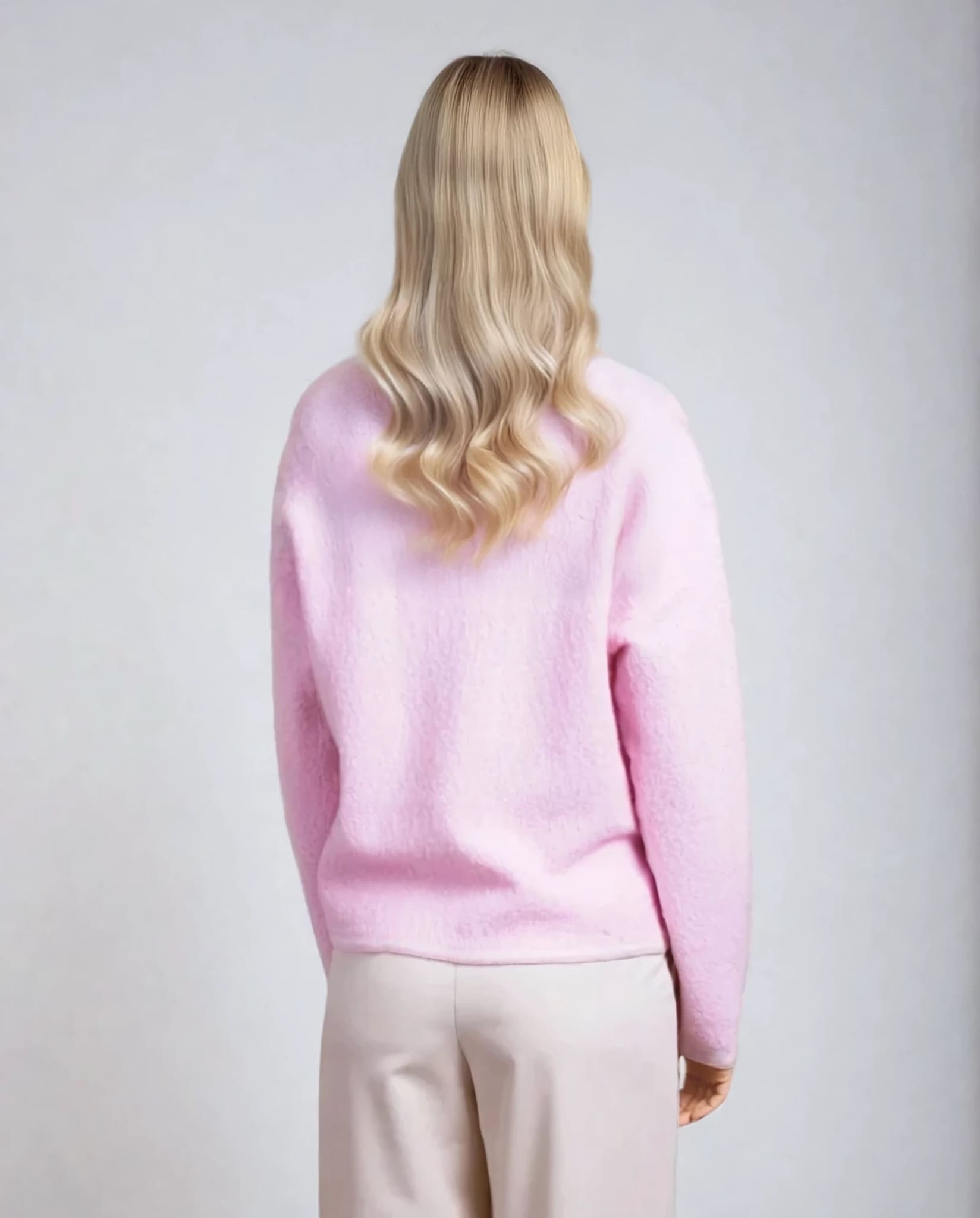 Back view of powder pink textured cardigan, soft women's knitwear from Coventina Collection.