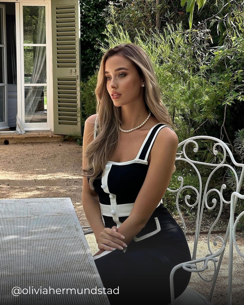 Olivia wearing a classic summer dress with white trim from Coventina Collection