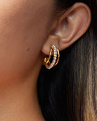 Triple hoop earrings in gold with pearls on model