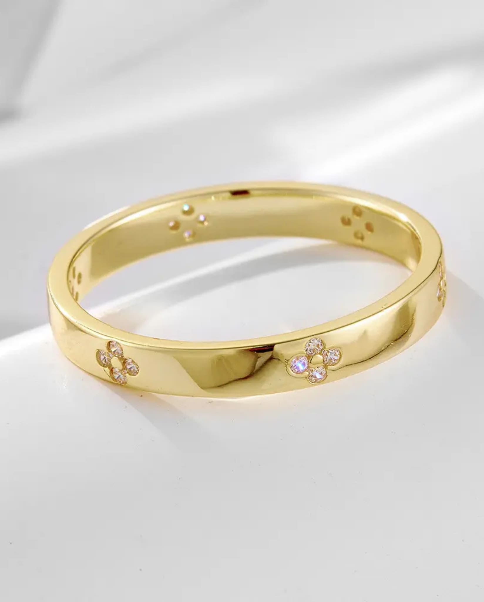 Gold band with floral diamond details from the two-piece radiant ring set.