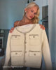 Aino showcasing the white cardigan jacket from Coventina Collection